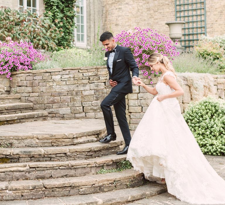 Bride in Lace Pronovias Wedding Dress and Groom in Black Tie Suit