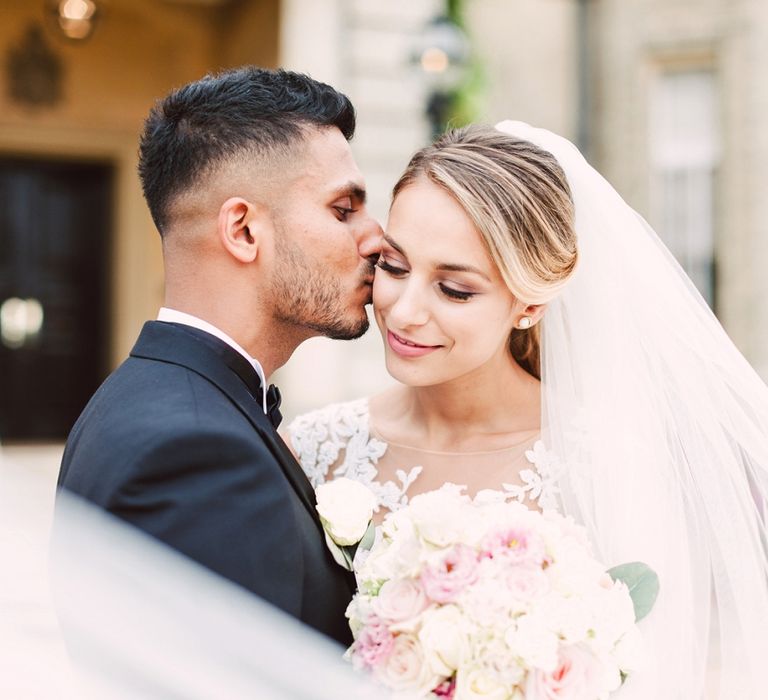 Groom Kissing His Bride