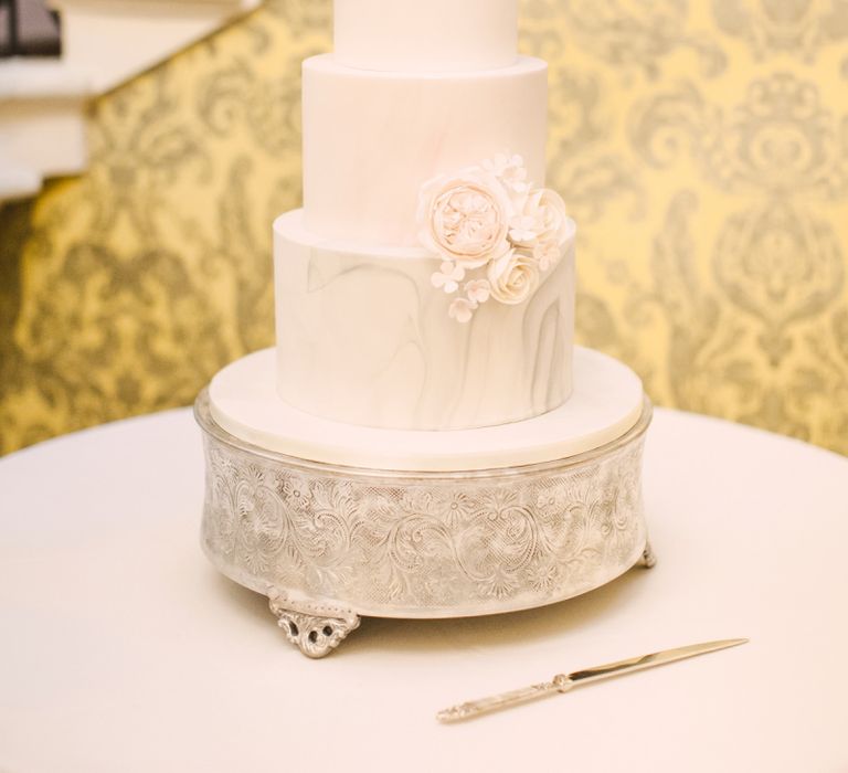 Elegant White Wedding Cake with Marble Bottom Tier and Rose Decor