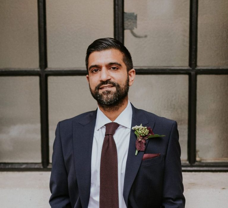 Groom in navy suit and burgundy tie at Town Hall wedding