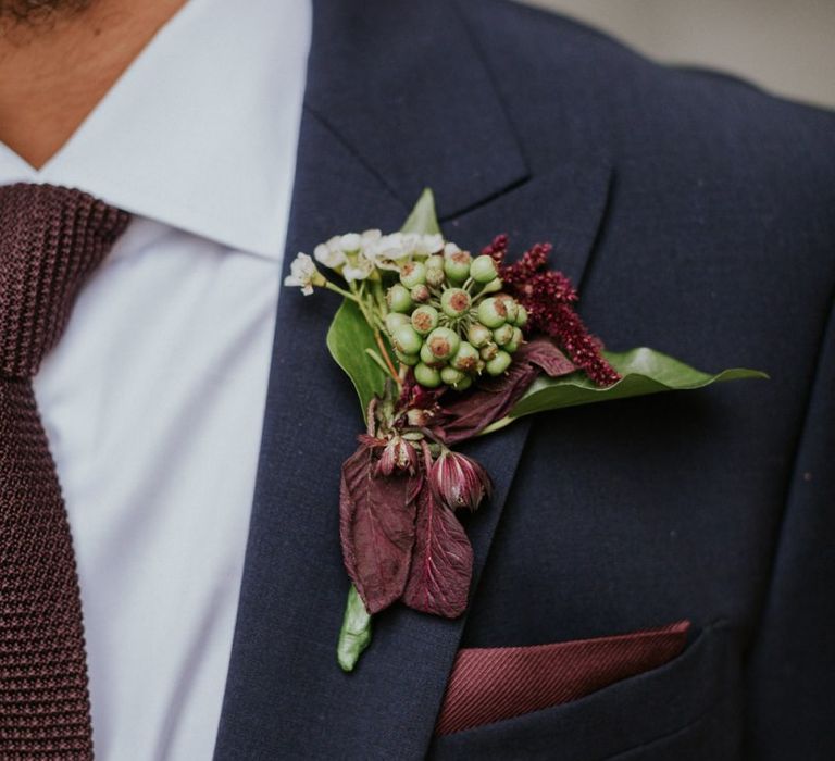 Berry buttonhole with deep red foliage