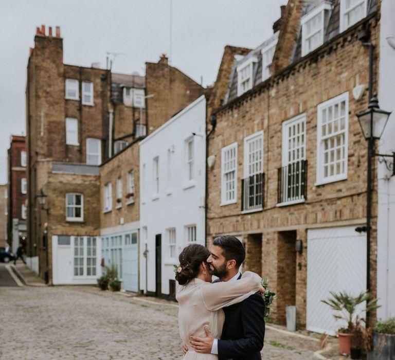 Bride and groom embracing in London Streets