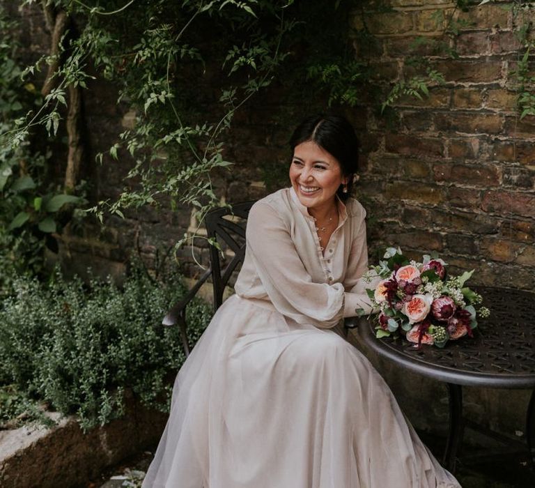 Bride sitting at a table in a tulle skirt