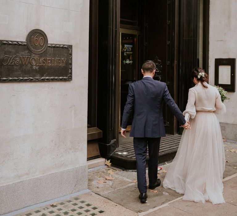 Bride and groom entering their intimate wedding reception venue