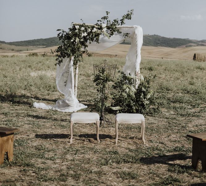 Wedding ceremony decor with flowers and drapes