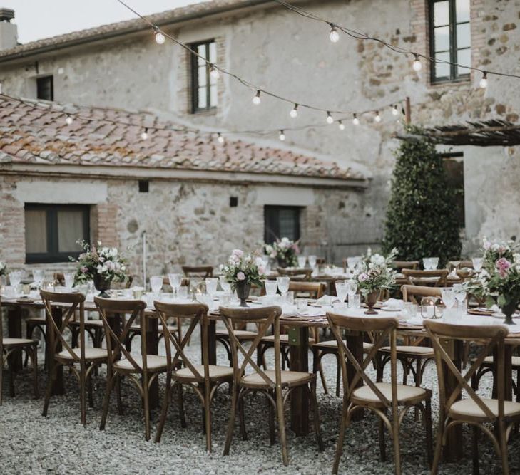 Outdoor wedding breakfast with festoon lighting