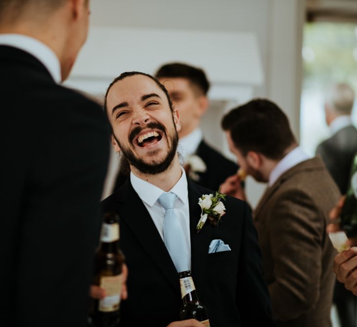 Wedding guests laughing at socially distanced wedding