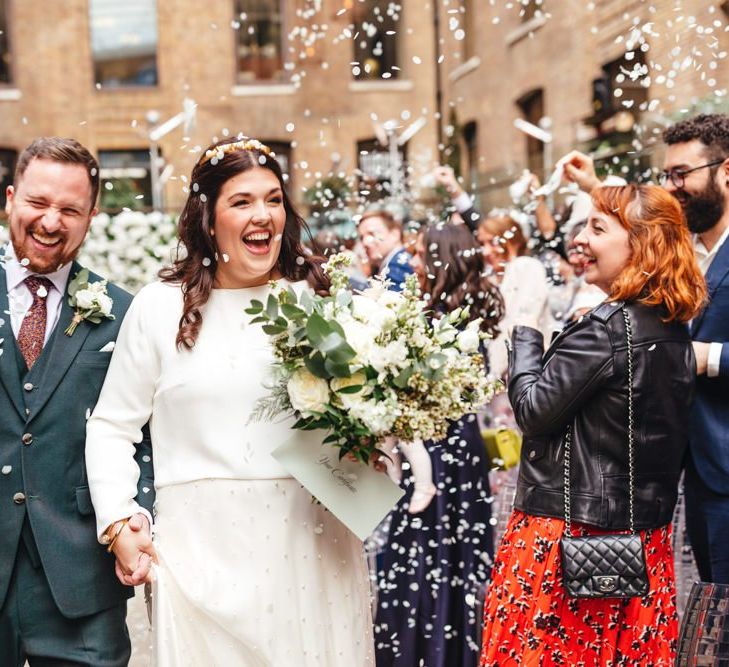 Confetti shot for spring courtyard wedding at Devonshire Terrace with white floral decor