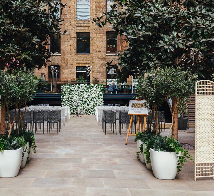 Spring courtyard wedding at Devonshire Terrace with white floral decor