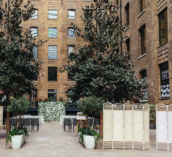 Spring courtyard wedding at Devonshire Terrace with white floral decor