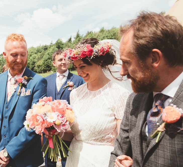 Wedding Ceremony | Bride in Lace Watters Gown &amp; Colourful Flower Crown | Groom in Navy Suit | Bright Festival Themed Outdoor Ceremony &amp; Tipi Weeding |  Maryanne Weddings | Framed Beauty Film