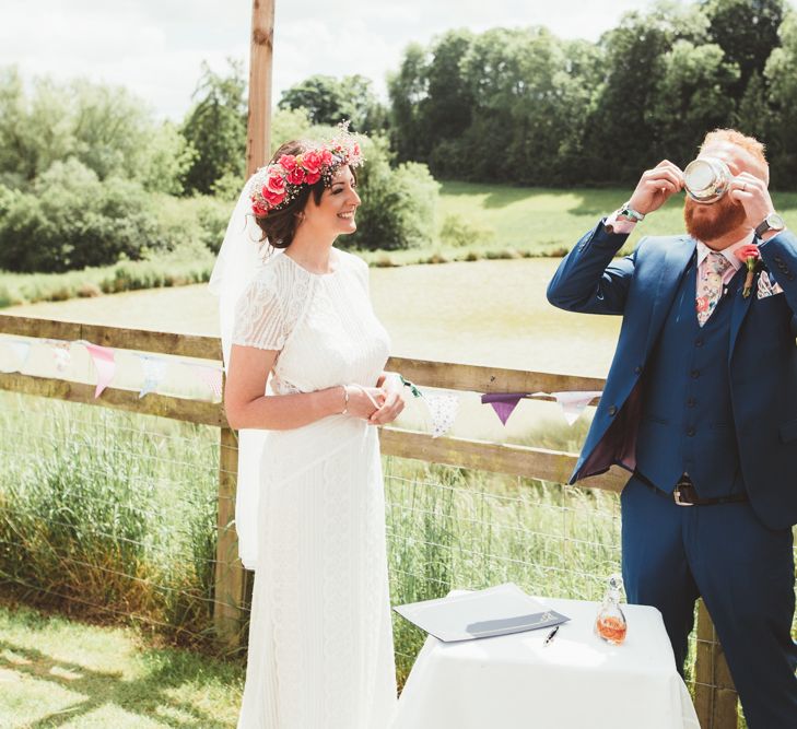 Wedding Ceremony | Bride in Lace Watters Gown &amp; Colourful Flower Crown | Groom in Navy Suit | Bright Festival Themed Outdoor Ceremony &amp; Tipi Weeding |  Maryanne Weddings | Framed Beauty Film