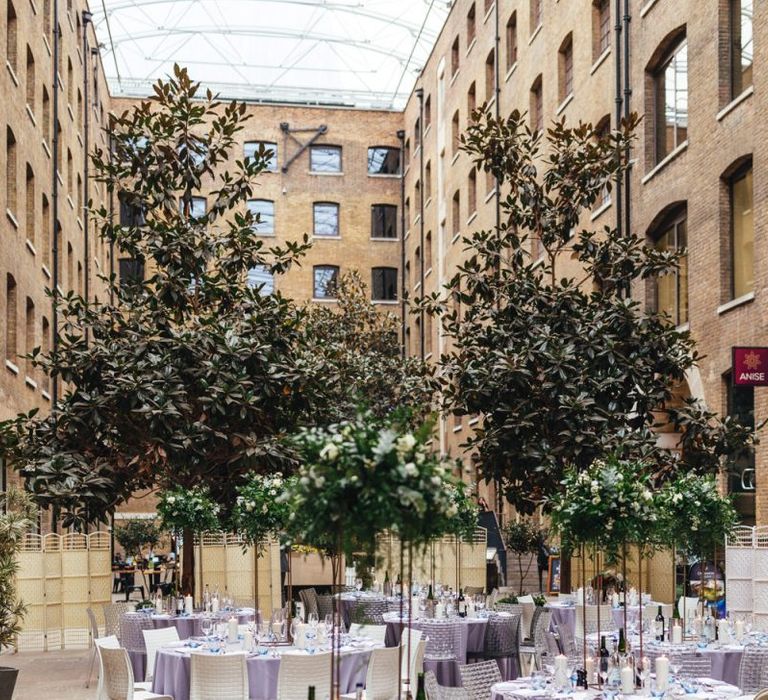 Devonshire Terrace courtyard reception with raised foliage table arrangements and candles