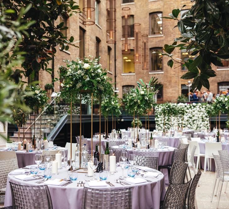 Devonshire Terrace courtyard reception with raised foliage table arrangements and candles