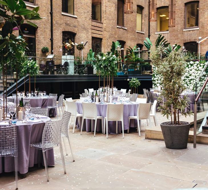 Devonshire Terrace courtyard reception with raised foliage table arrangements and candles