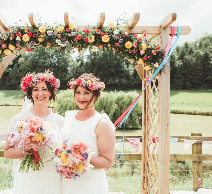 Bride &amp; Bridesmaids in Colourful Flower Crowns | Bright Festival Themed Outdoor Ceremony &amp; Tipi Weeding |  Maryanne Weddings | Framed Beauty Film