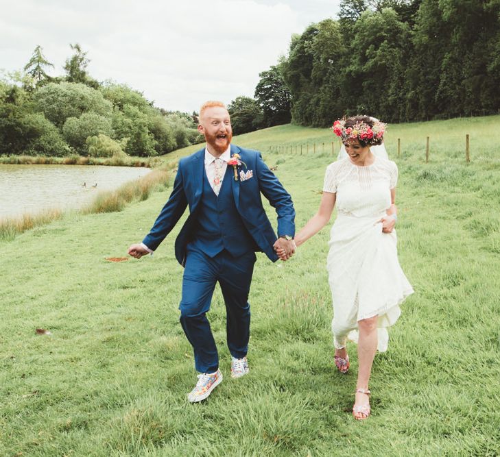 Bride in Lace Watters Wedding Dress | Groom in Navy Suit | Bright Festival Themed Outdoor Ceremony &amp; Tipi Weeding |  Maryanne Weddings | Framed Beauty Film