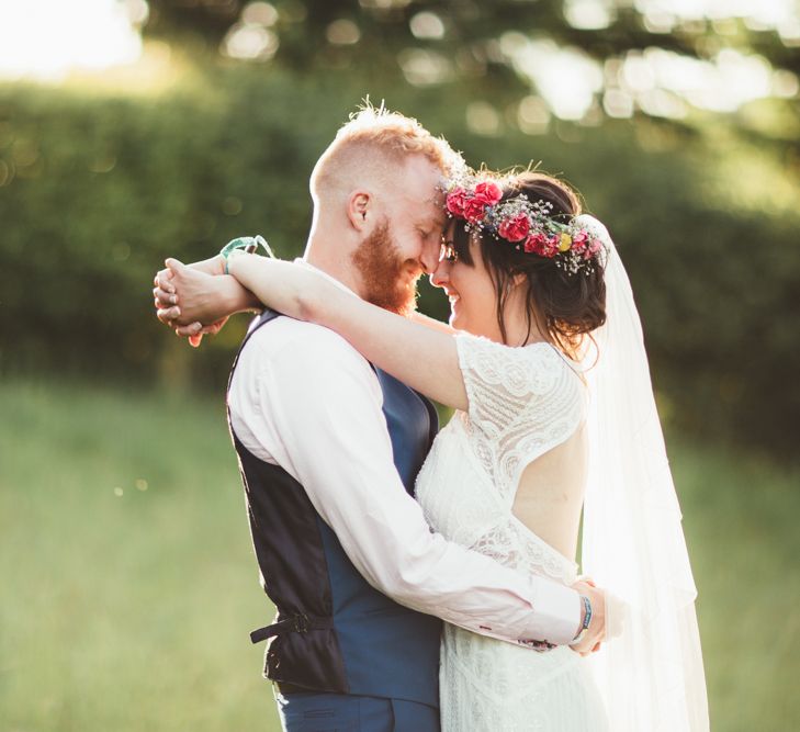 Bride in Lace Watters Wedding Dress | Groom in Navy Suit | Bright Festival Themed Outdoor Ceremony &amp; Tipi Weeding |  Maryanne Weddings | Framed Beauty Film