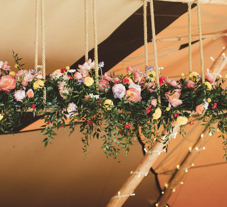 Hanging Floral Installation with Peonies | Bright Festival Themed Outdoor Ceremony &amp; Tipi Weeding |  Maryanne Weddings | Framed Beauty Film