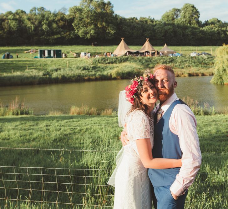 Bride in Lace Watters Wedding Dress | Groom in Navy Suit | Bright Festival Themed Outdoor Ceremony &amp; Tipi Weeding |  Maryanne Weddings | Framed Beauty Film