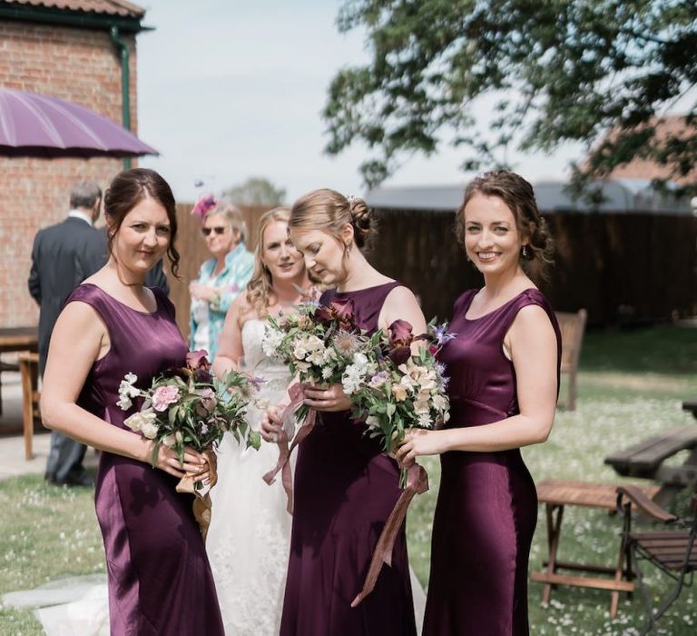 Bridesmaids in Long Satin Purple Dresses from Ghost Fashion