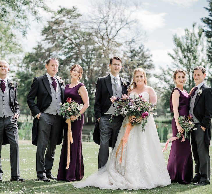 Wedding Party Portrait with Bridesmaids in Purple Dresses and Groomsmen in Matching Purple Cravats