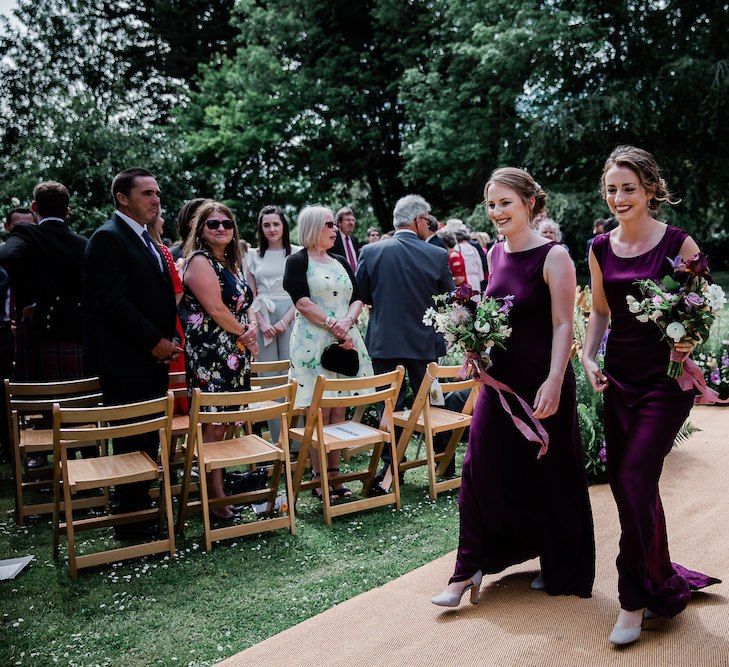 Bridesmaids in Ghost Deep Purple Satin Bridesmaids Dresses Walking Down the Aisle