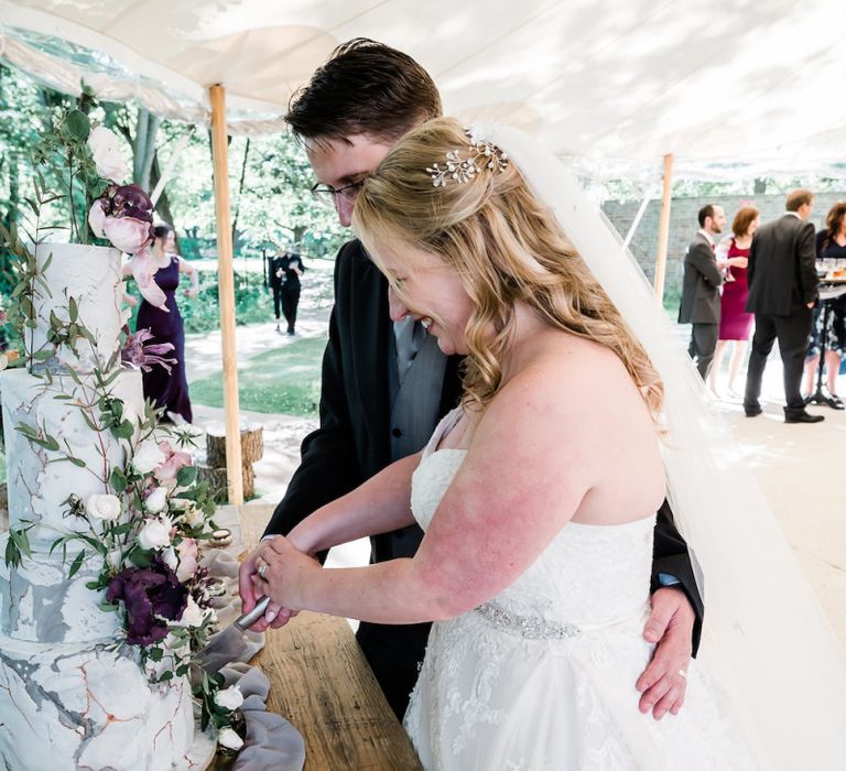 Bride and Groom Cutting Their Wedding Cake