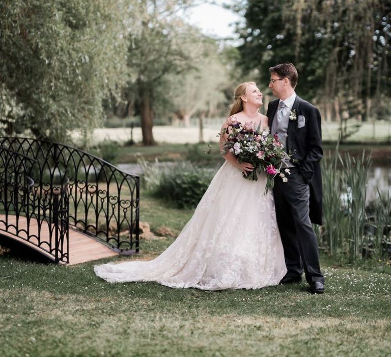 Bride in Lace Sophia Tolli Wedding Dress and Groom in Traditional Tails