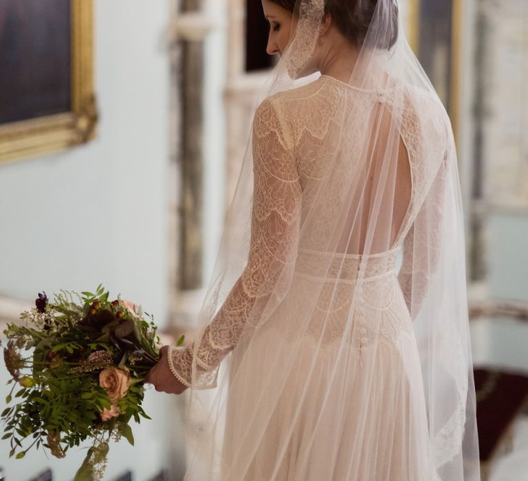 Bride in Delicate Lace Lihi Hod Sophia Wedding Dress with Long Sleeves Standing in the Grand Hall of Mount Stuart in Scotland