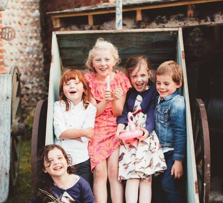 Little Wedding Guests Sitting in a Cart Playing