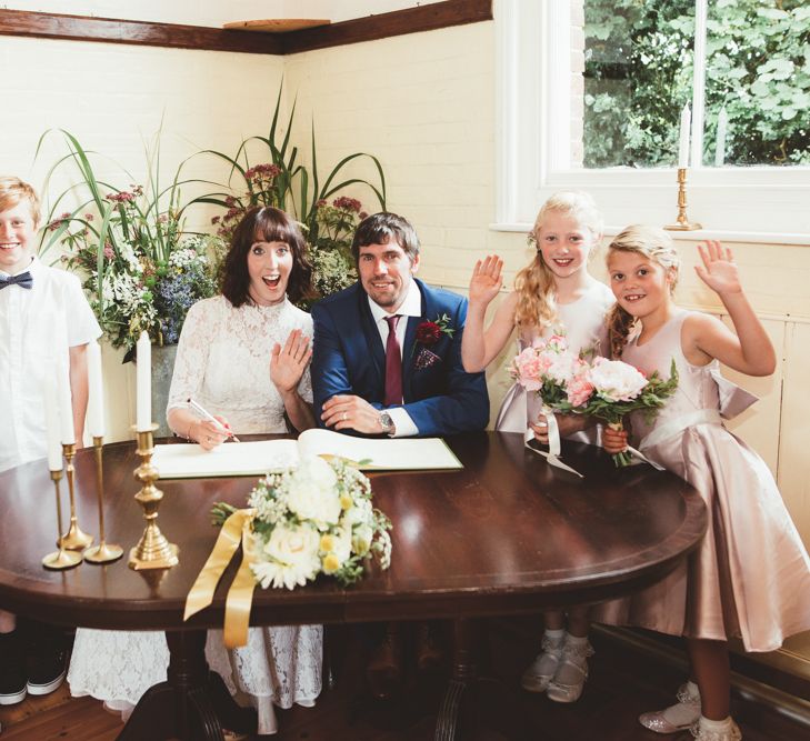 Bride in Lace Wedding Dress from Hope &amp; Harlequin and Groom in Navy Hugo Boss Suit with Wedding Party