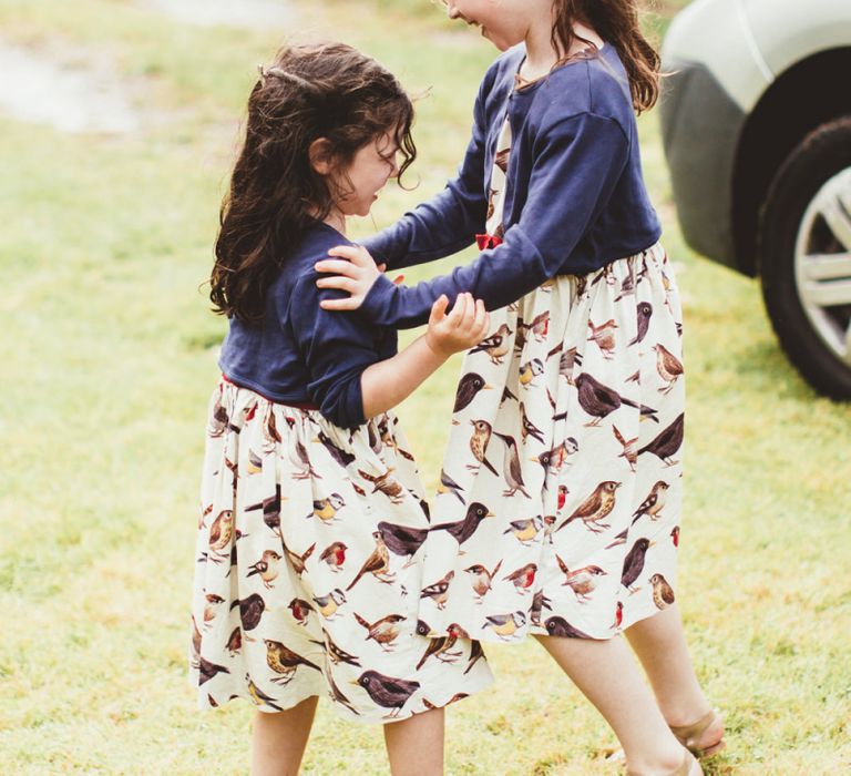 Little Girls in Bird Print Dresses and Navy Cardigans