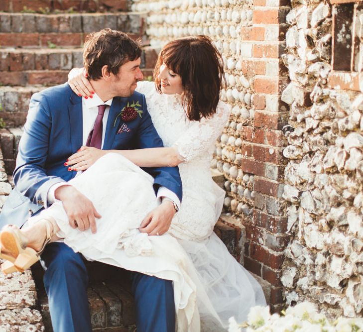 Bride in Lace Wedding Dress from Hope &amp; Harlequin and Groom in Navy Hugo Boss Suit  Sitting on Steps