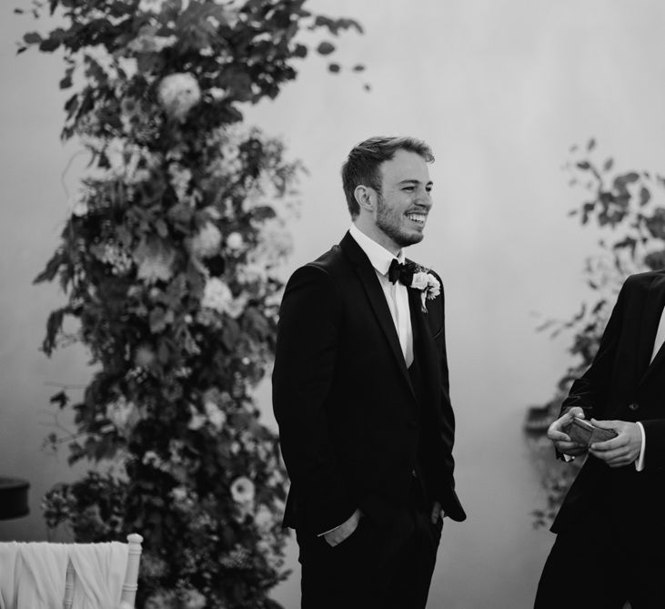 Groom and best man waiting at the altar