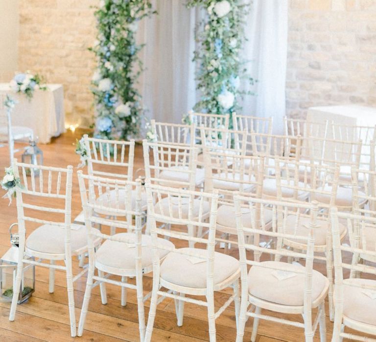 Ceremony Room at at The Priory Barns and Cottages with Blue and White Floral Arch Altar