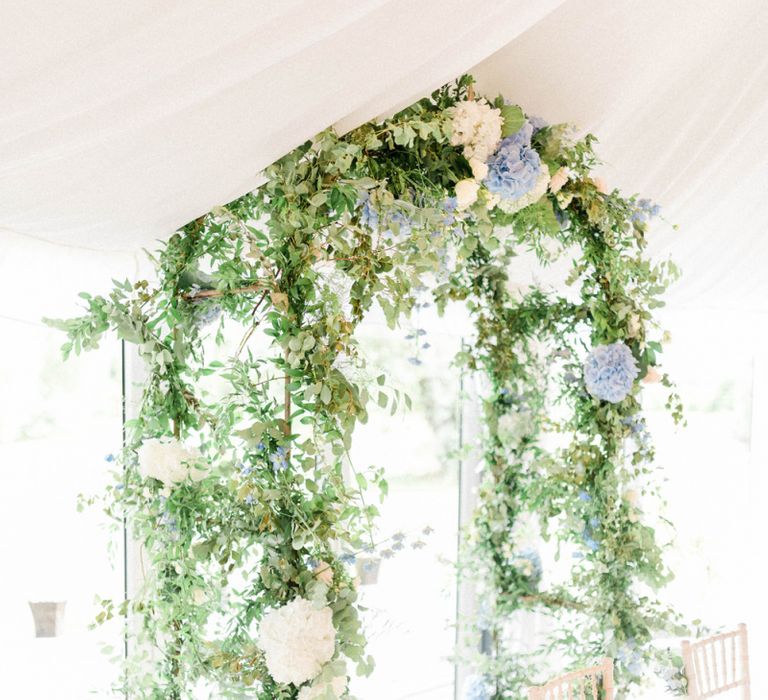 Blue and White Hydrangea Flowers Intertwined with Foliage