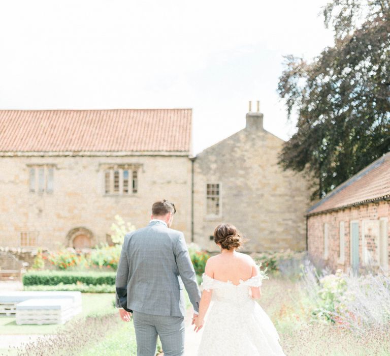 Bride in Appliqué Ian Stuart Wedding Dress and Groom in Most Suitable Blue Check Wedding Suit