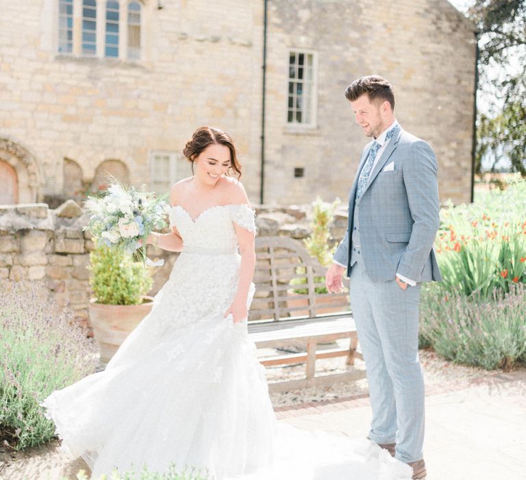 Groom in Most Suitable Blue Check Wedding Suit Watching His Bride Twirling in a Appliqué Ian Stuart Wedding Dress