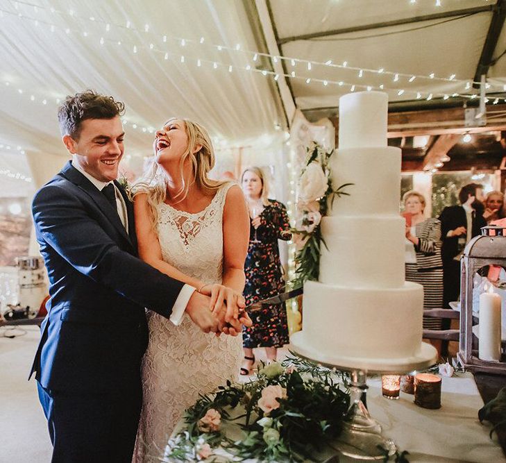 Cutting the Cake | Bride in Lace Mikaella Bridal Gown | Groom in Navy Remus Uomo Suit &amp; Grey Waistcoat | Blush, Rustic Luxe Wedding at Ever After, Dartmoor | Dan Ward Photography | CupcakeVideos