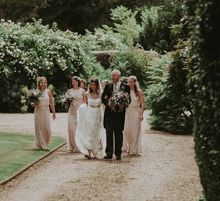 Bridal Entrance in LaceRime Arodaky Gown | Bridesmaids in Pink Monsoon Dresses | English Country Garden Marquee Wedding at the Family Home on the Isle of Wight | Jason Mark Harris Photography