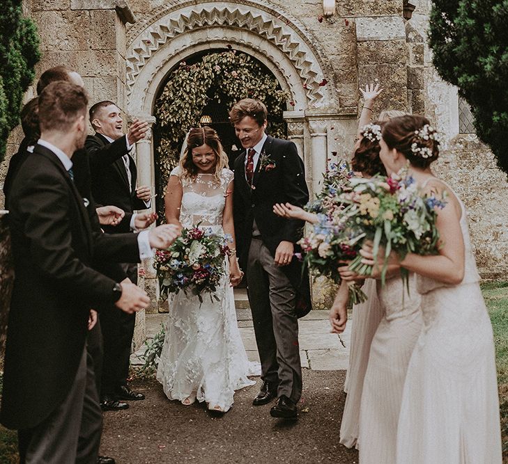 Confetti Moment | Bride in Lace Rime Arodaky Wedding Dress | Groom in Henry Herbert Tailors Suit | English Country Garden Marquee Wedding at the Family Home on the Isle of Wight | Jason Mark Harris Photography