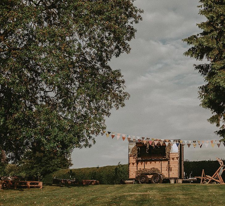 Horse Box Bar | Bunting Wedding Decor | English Country Garden Marquee Wedding at the Family Home on the Isle of Wight | Jason Mark Harris Photography