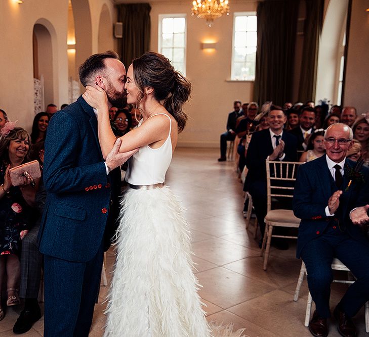 Bride in Charlie Brear Payton Bridal Gown &amp; Piora Feather Skirt and Groom in Three Piece Wool Suit