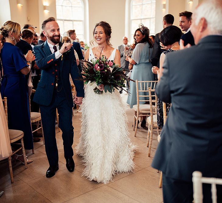 Bride in Charlie Brear Payton Bridal Gown &amp; Piora Feather Skirt and Groom in Three Piece Wool Suit