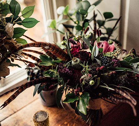 Foliage,  Red Flowers and Pheasant Feather Floral Arrangement