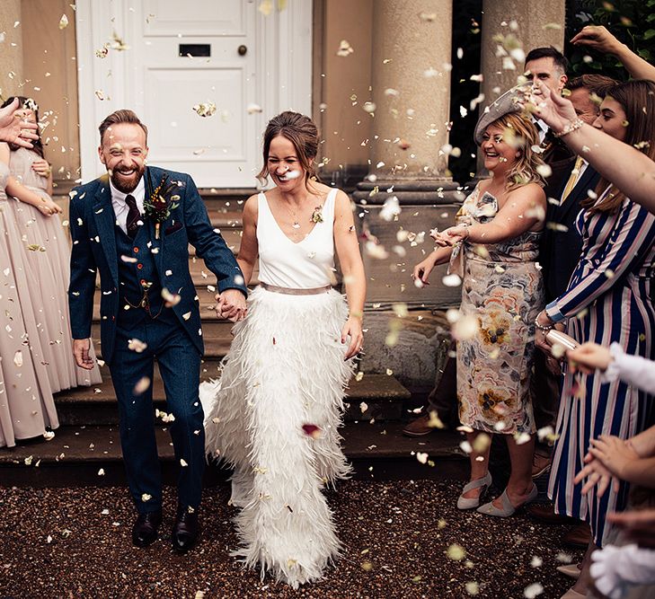 Confetti Moment with Bride in Charlie Brear Payton Bridal Gown &amp; Piora Feather Skirt and Groom in Three Piece Wool Suit