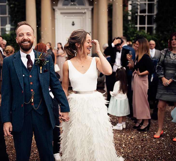 Confetti Moment with Bride in Charlie Brear Payton Bridal Gown &amp; Piora Feather Skirt and Groom in Three Piece Wool Suit