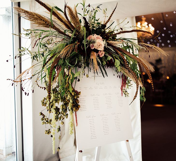 Table Plan with Floral Arrangement including Pampas Grass, Pheasant Feathers, Foliage and Red Flowers