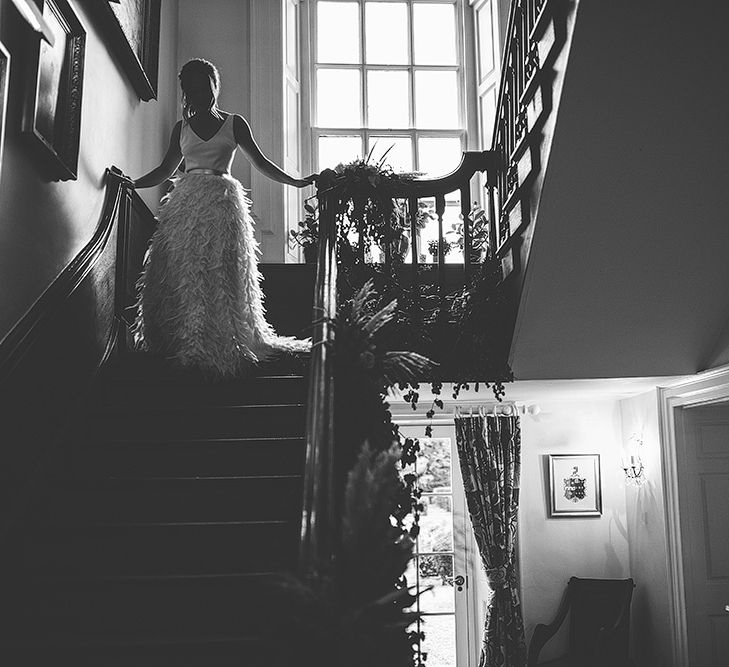 Bride Walking Down the Stairs  in Charlie Brear Payton Bridal Gown &amp; Piora Feather Skirt